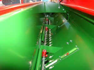 A green and red machine is sitting on top of a table.
