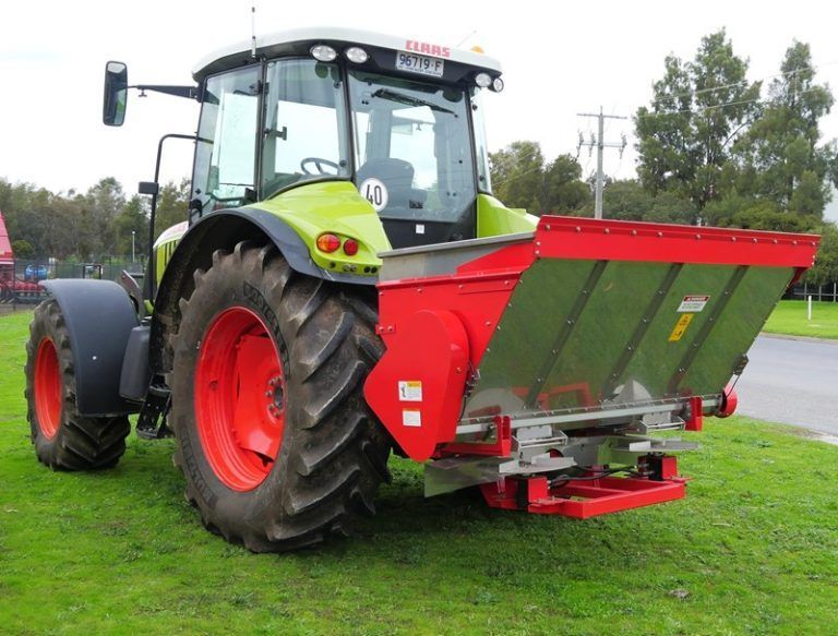 A line drawing of a tractor on a gray background.