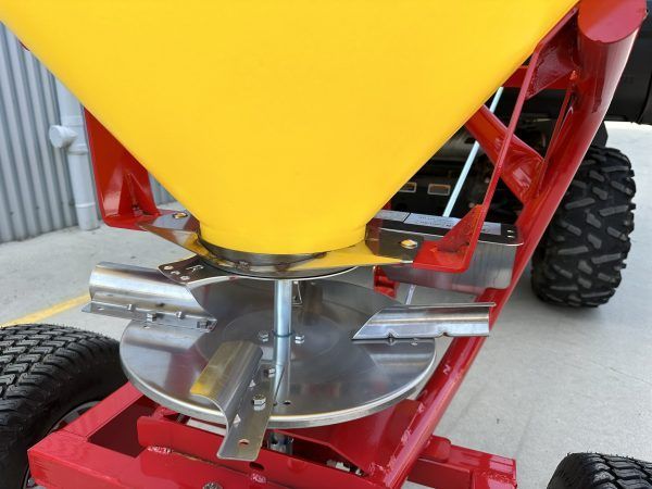 A red and yellow tractor with a yellow cone on top