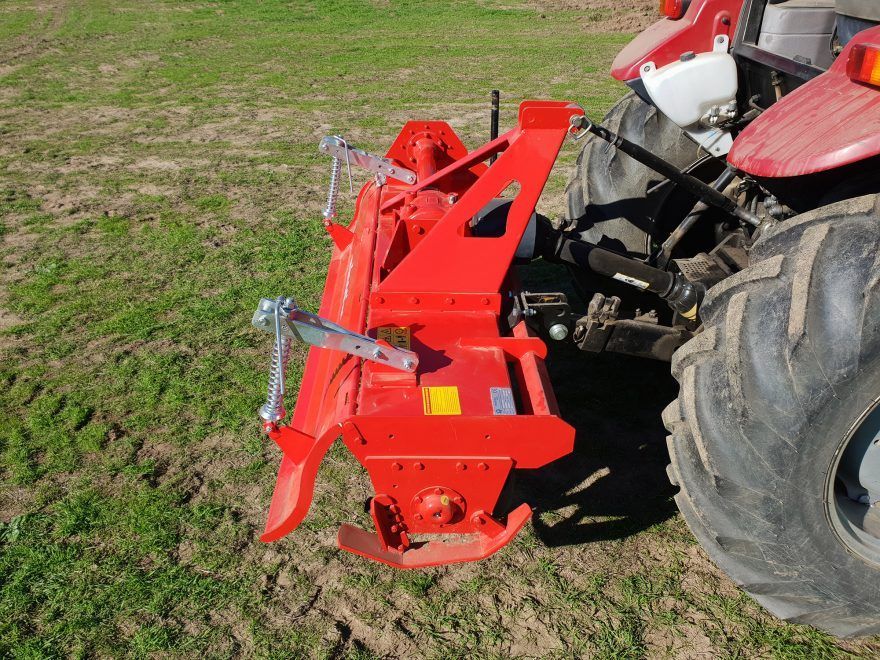A line drawing of a tractor on a gray background.