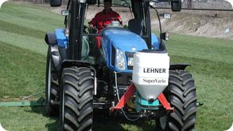 A man is riding a green atv in a field.
