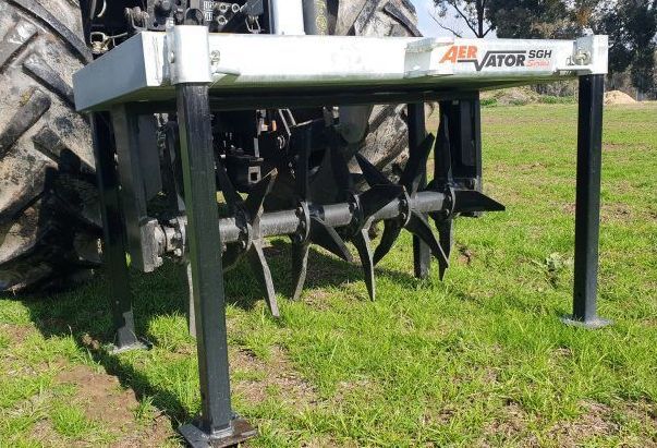 A tractor with a farmtech aerator attached to it