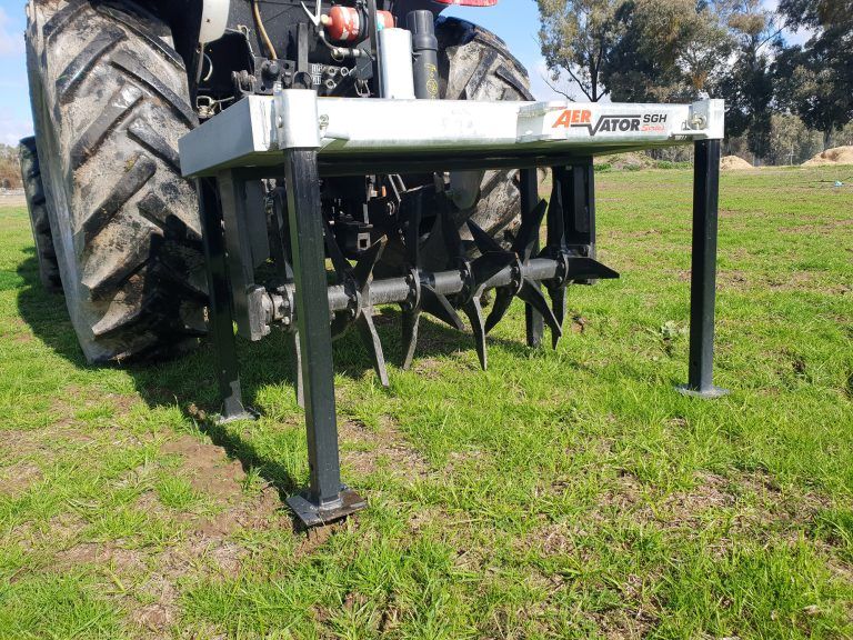 A tractor with a farmtech aerator attached to it