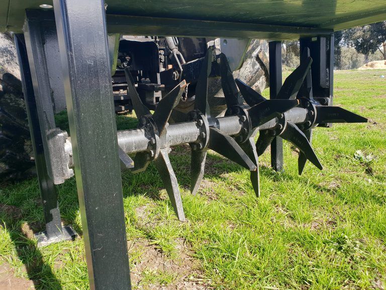 A close up of a machine with a lot of blades on it in a field.