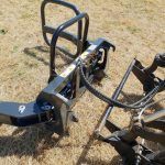 A trailer is sitting on top of a dry grass field.