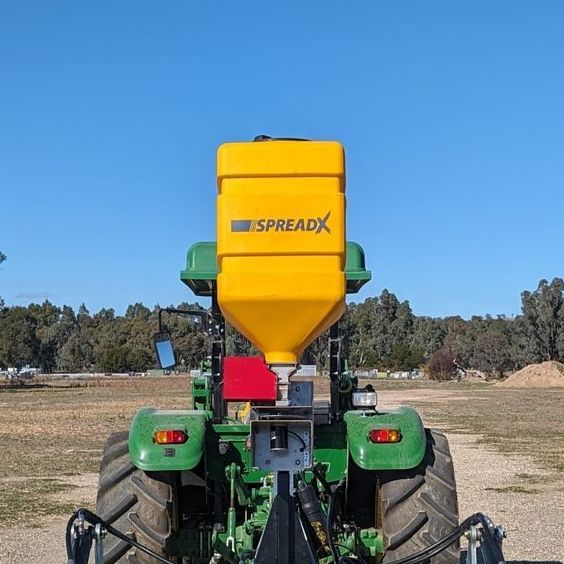 A green tractor with a white container that says lehner on it