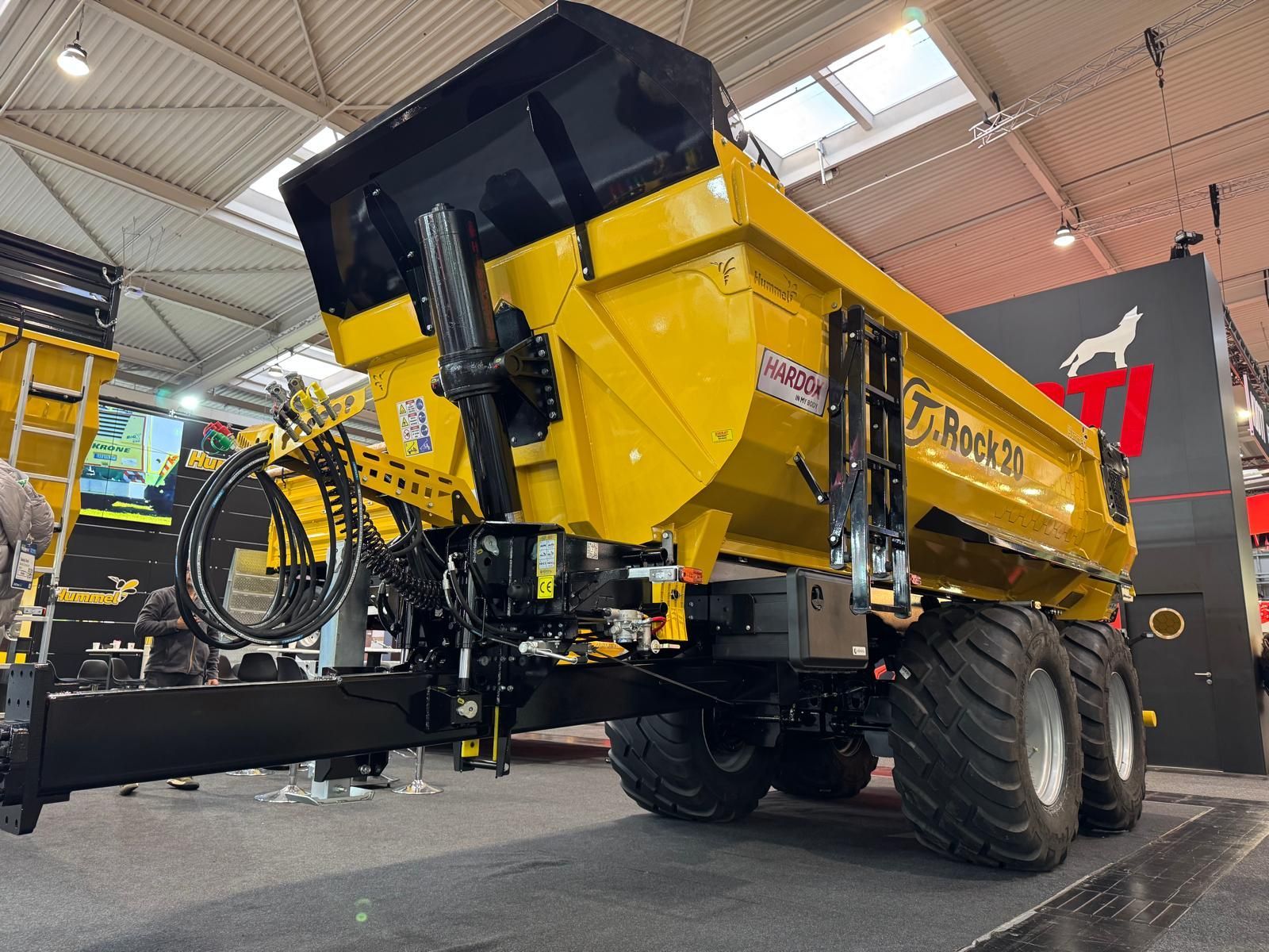 A yellow dump truck with a trailer attached to it.