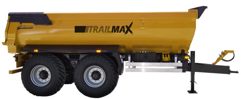 A yellow dump truck with a trailmax trailer attached to it.