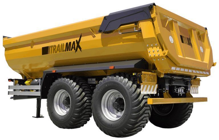 A yellow dump truck with trailmax written on the side
