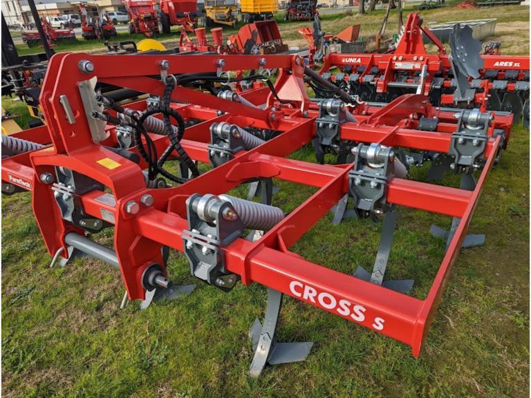 A red and silver machine with the word cross on it