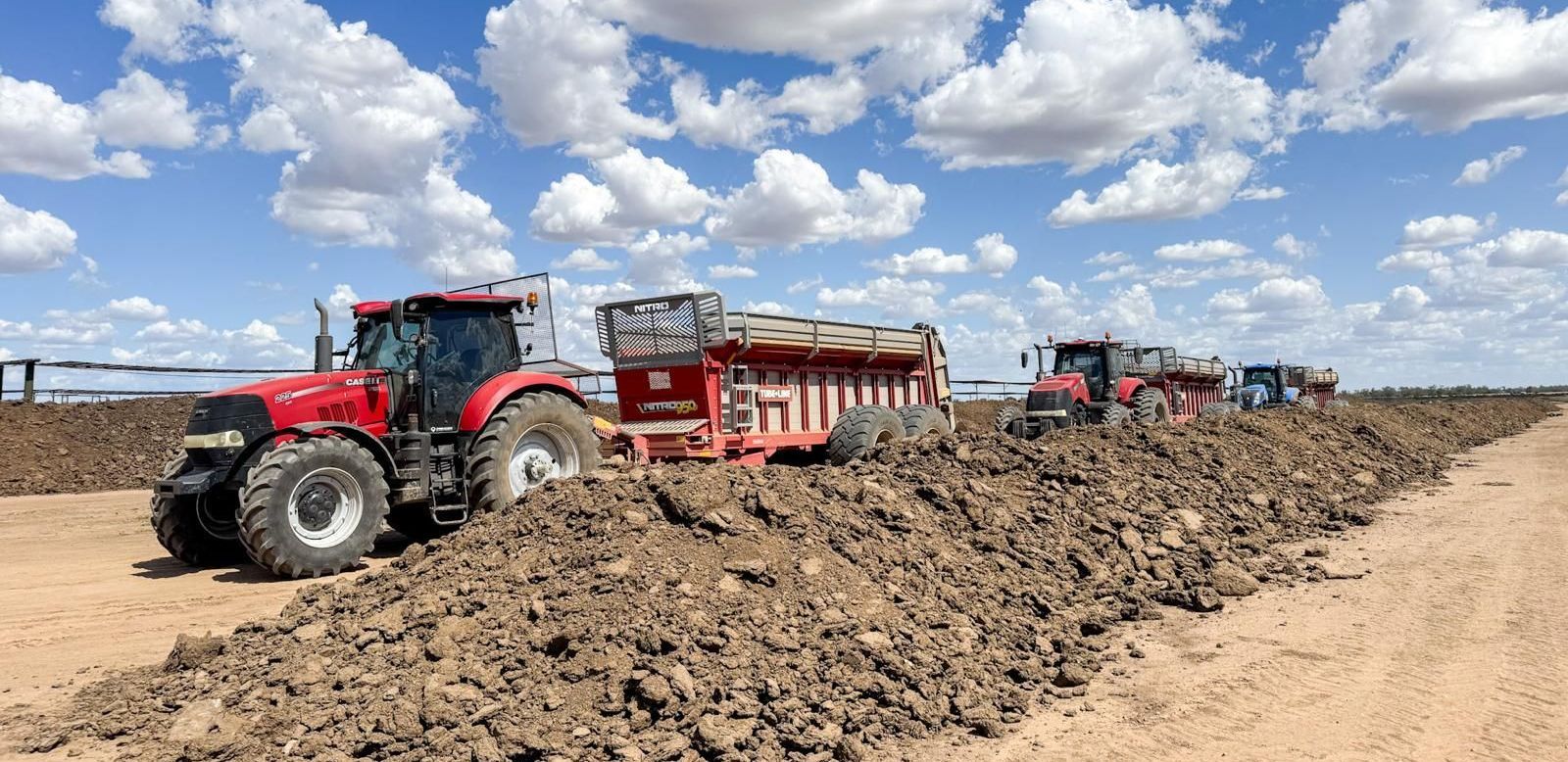 A tractor is pulling a trailer in a field.