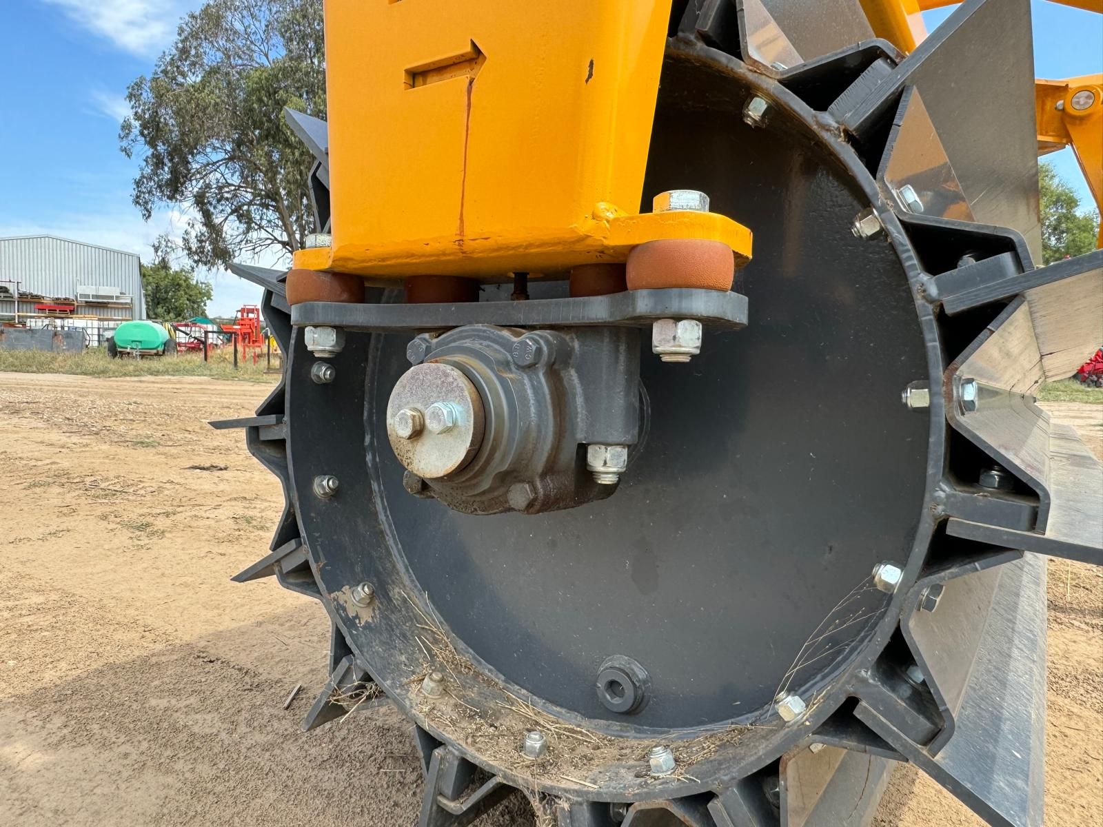 A close up of a wheel on a tractor in a field.