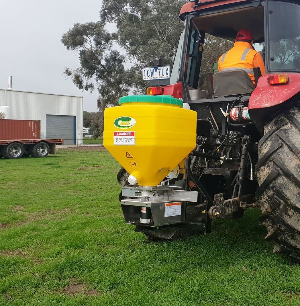 A green tractor with a white container that says lehner on it