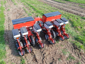 An aerial view of a row of planters in a field