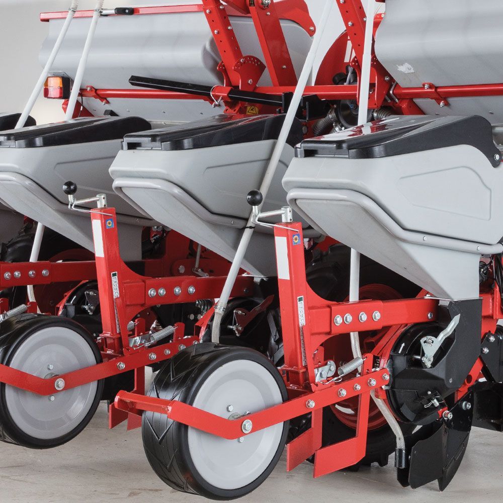 A row of red and gray planters with white wheels