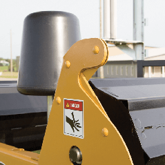 A close up of a tractor with a warning sign on it