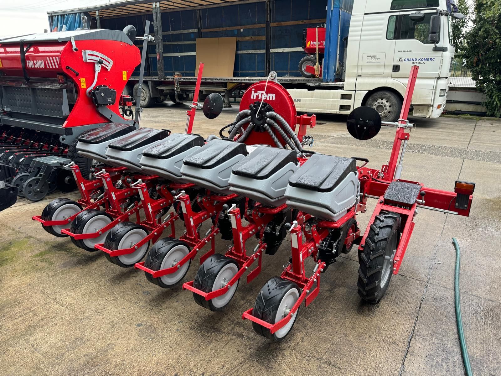 A row of red and gray planters with white wheels