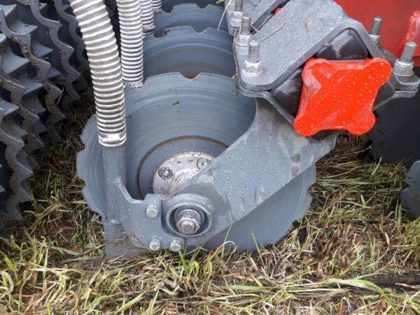 A close up of a machine with a red knob on it