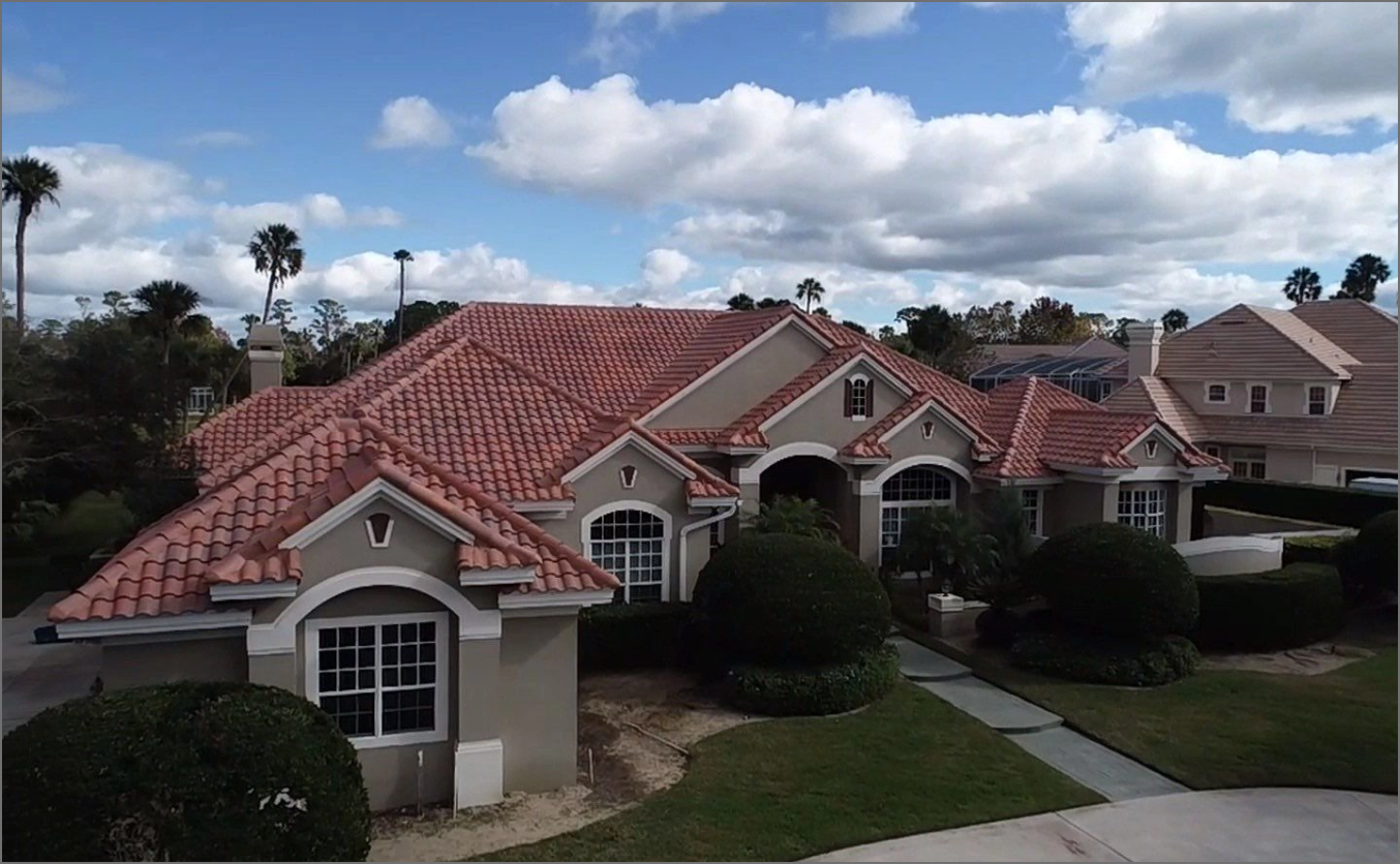 A large house with a red tile roof