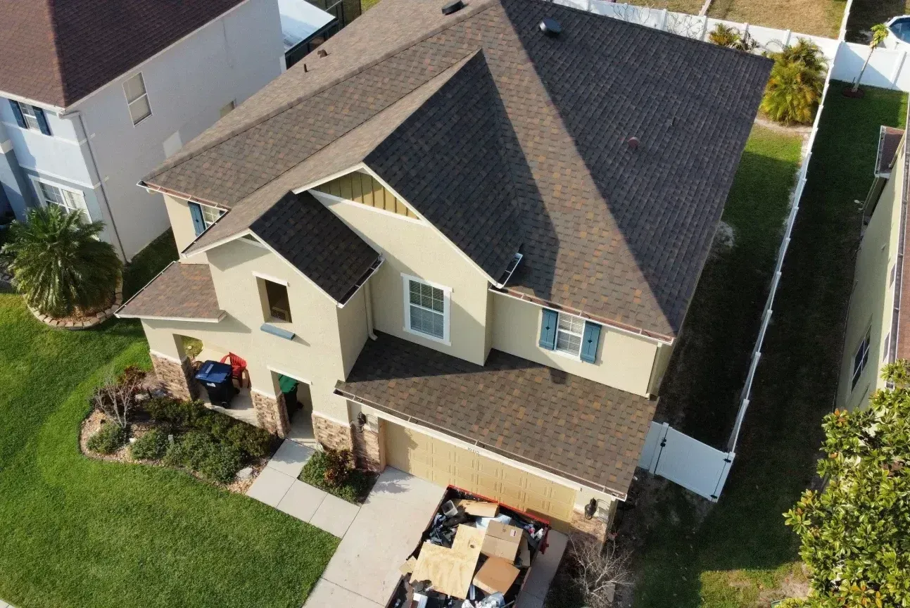 An aerial view of a house with a new roof.