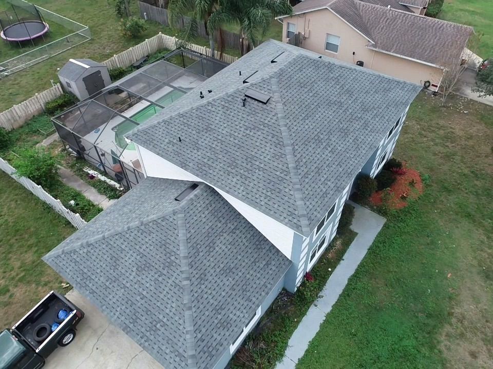 An aerial view of a house with a gray roof.