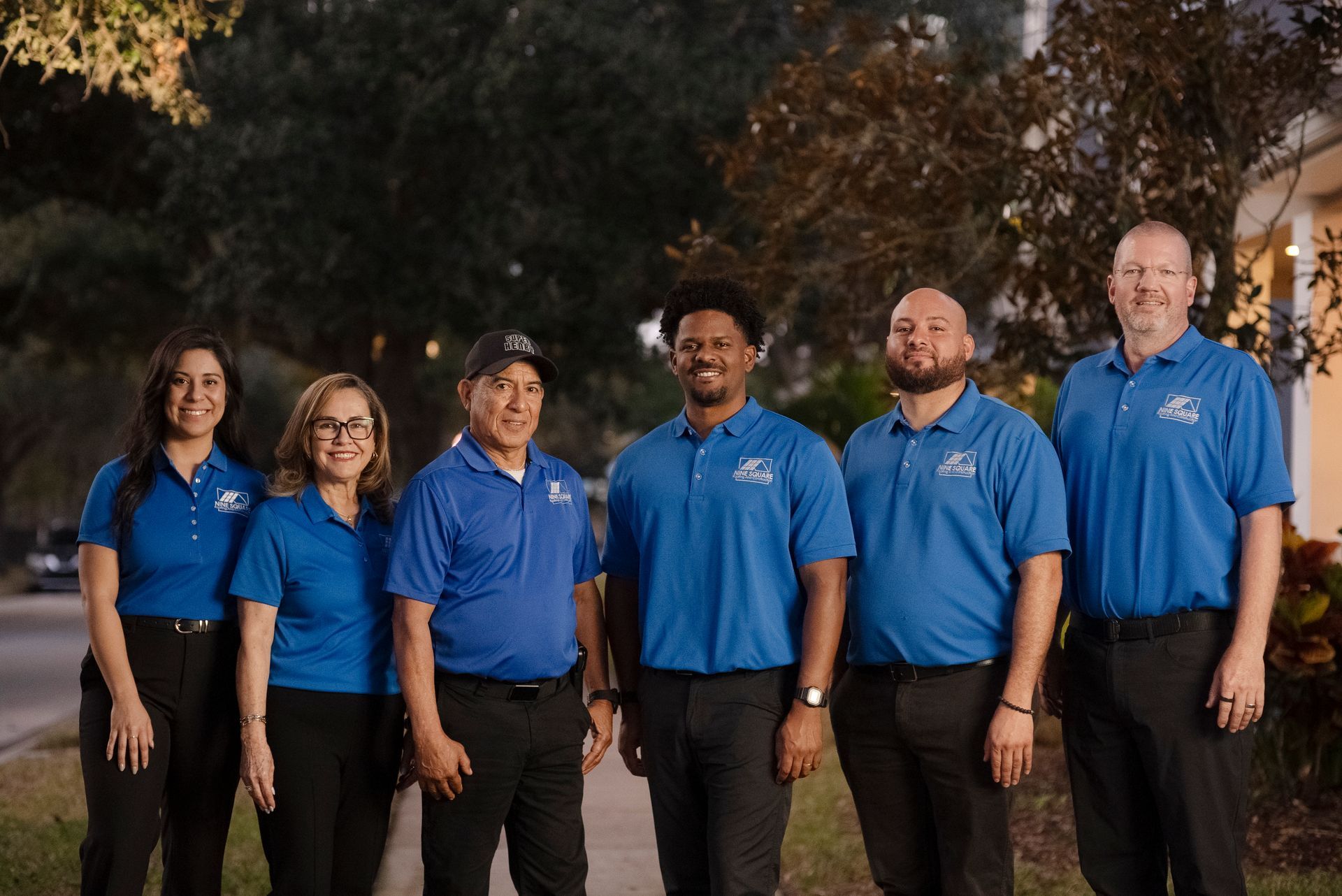 Nine Square team posing for a picture on a sidewalk.