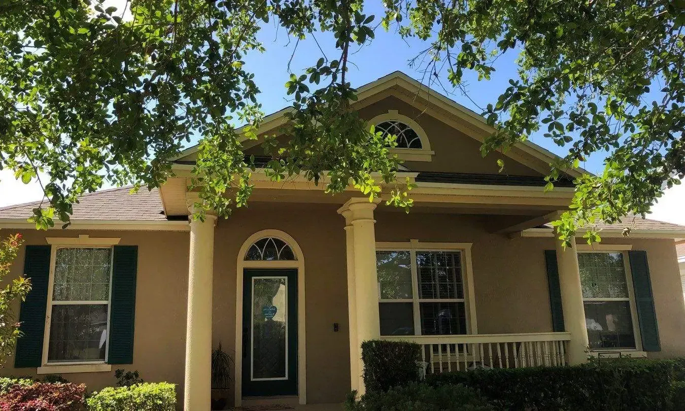 A house with a green door and blue shutters