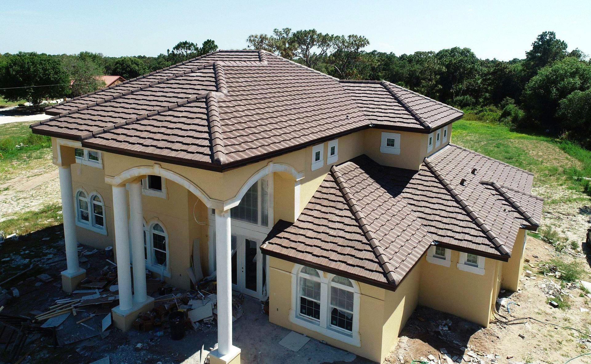 An aerial view of a house under construction with a tile roof.