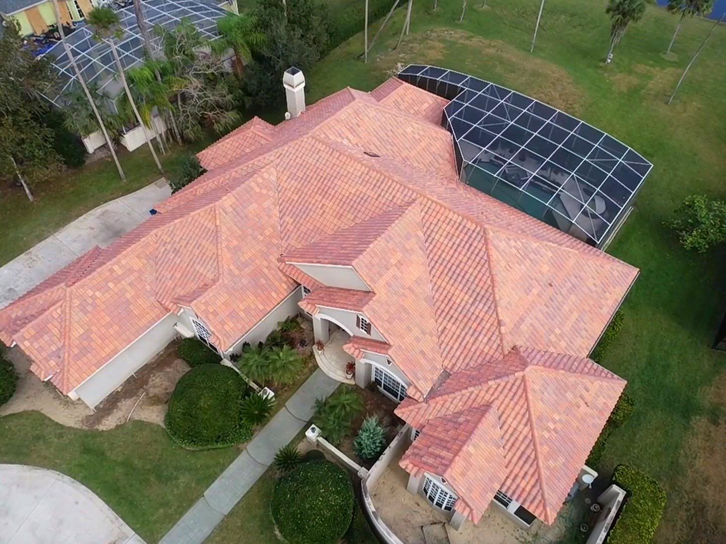 An aerial view of a large house with a red tiled roof