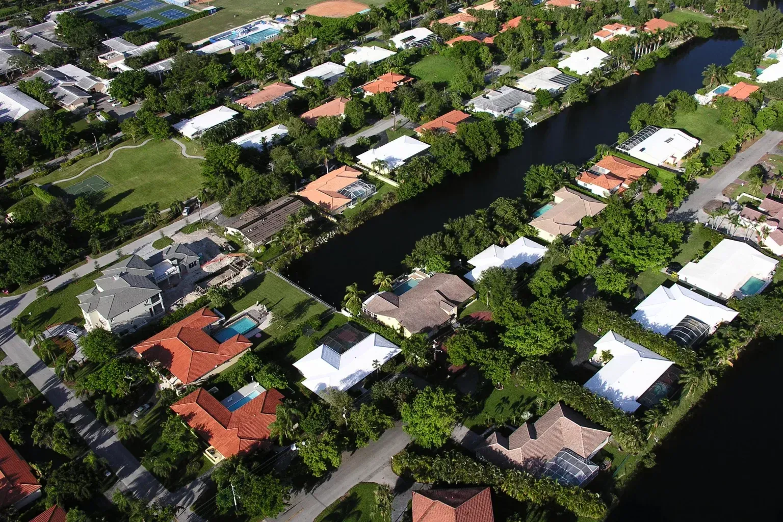 An aerial view of a residential area with lots of houses and trees