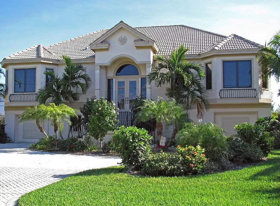 A large house with palm trees in front of it