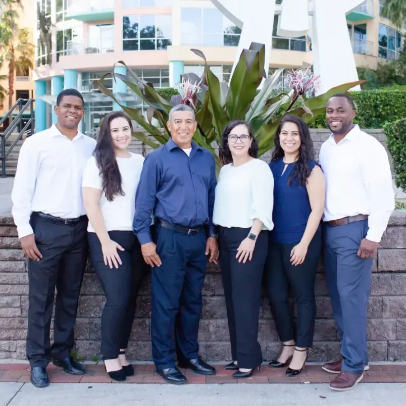 A group of people posing for a picture in front of a building