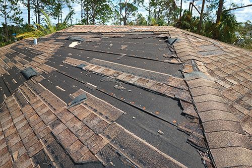 A roof that has been damaged by a storm and needs to be repaired.