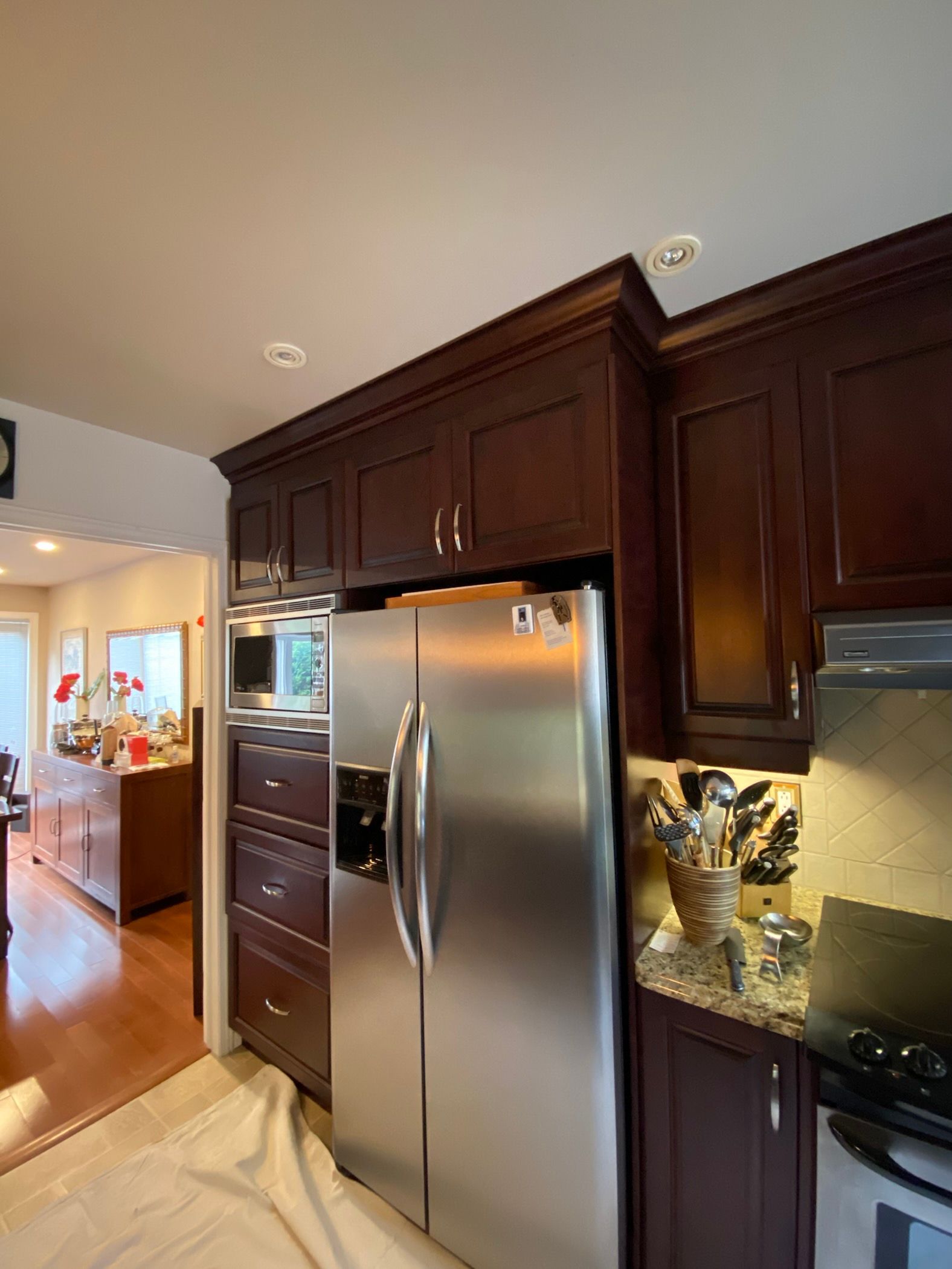 A kitchen with stainless steel appliances and wooden cabinets