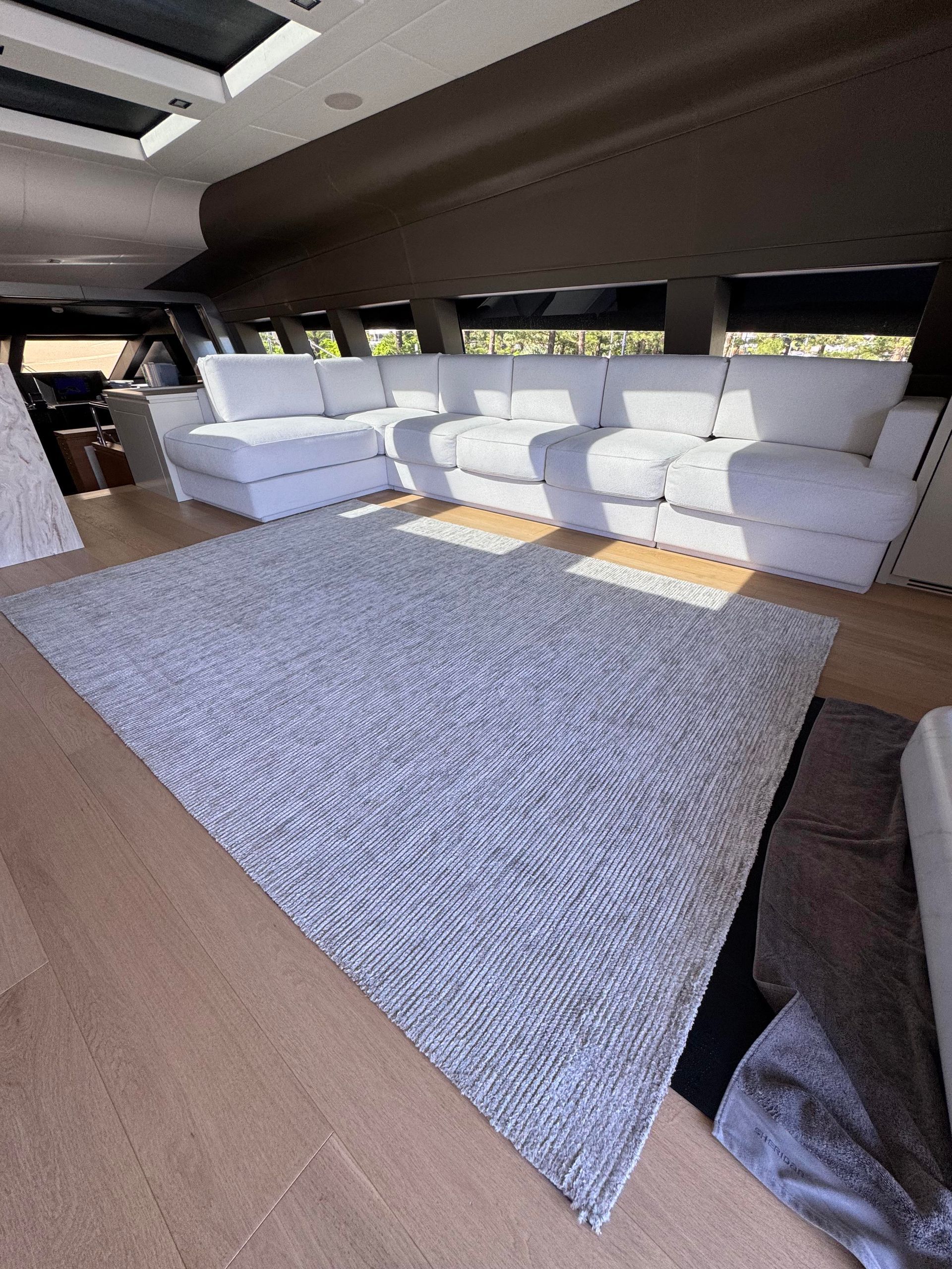 A White Rug is Sitting on a Wooden Floor — Gold Coast Carpet Cleaning Service in Surfers Paradise, QLD