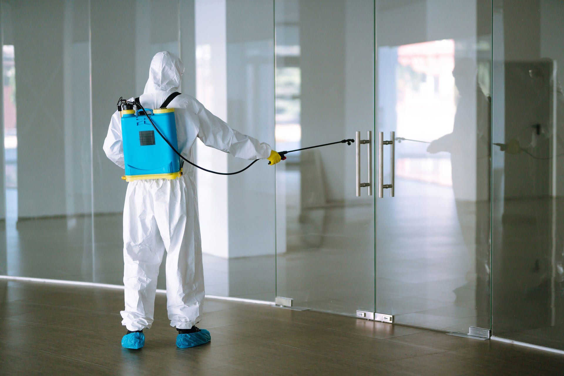 Man in Suit, Protective Gloves and Goggles Use Sprayer Equipment Disinfect - Shepparton, Vic - Vin Truscott Pest Control