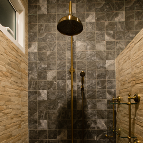 tiled shower with gold shower head