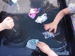 Pupils hand washing toys clothing