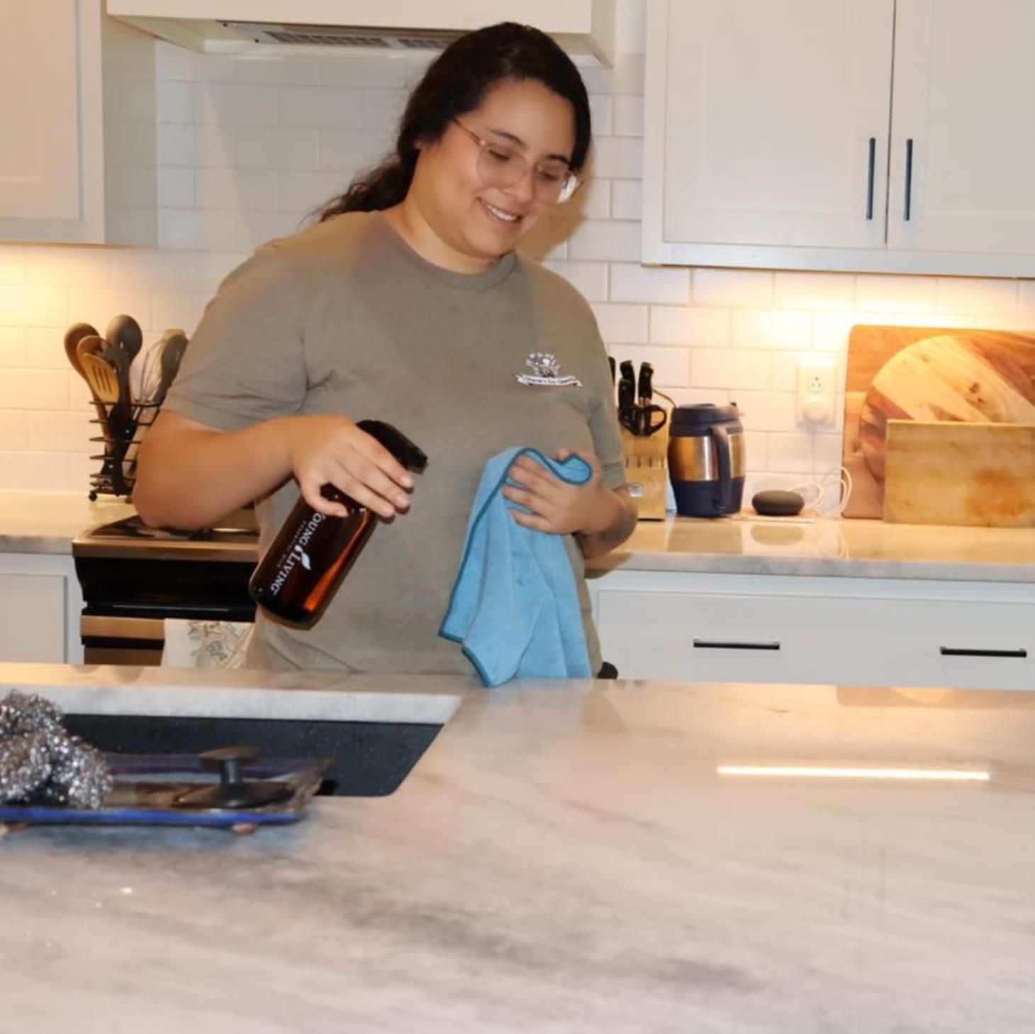 A person is using a vacuum cleaner to clean the carpet in a living room.