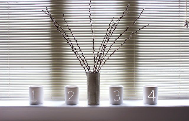 white venetian blinds with decor on windowsill