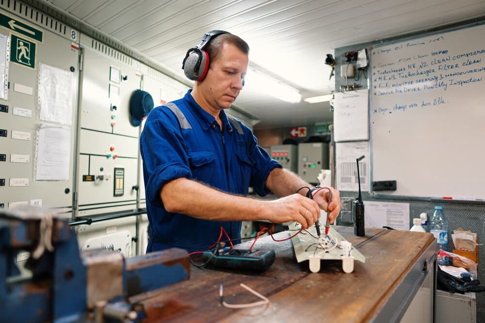 A Man Wearing Headphones is Working on a Piece of Equipment in a Workshop — Clarence Valley Auto Electrical in South Grafton, NSW