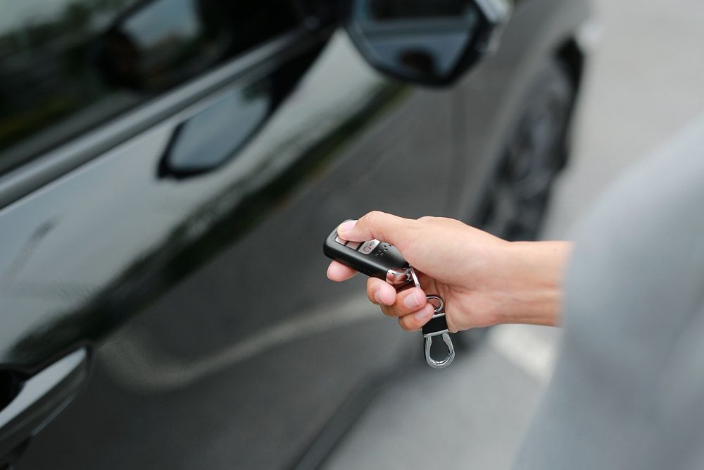 A Person is Using a Remote Control to Open a Car Door — Clarence Valley Auto Electrical in South Grafton, NSW