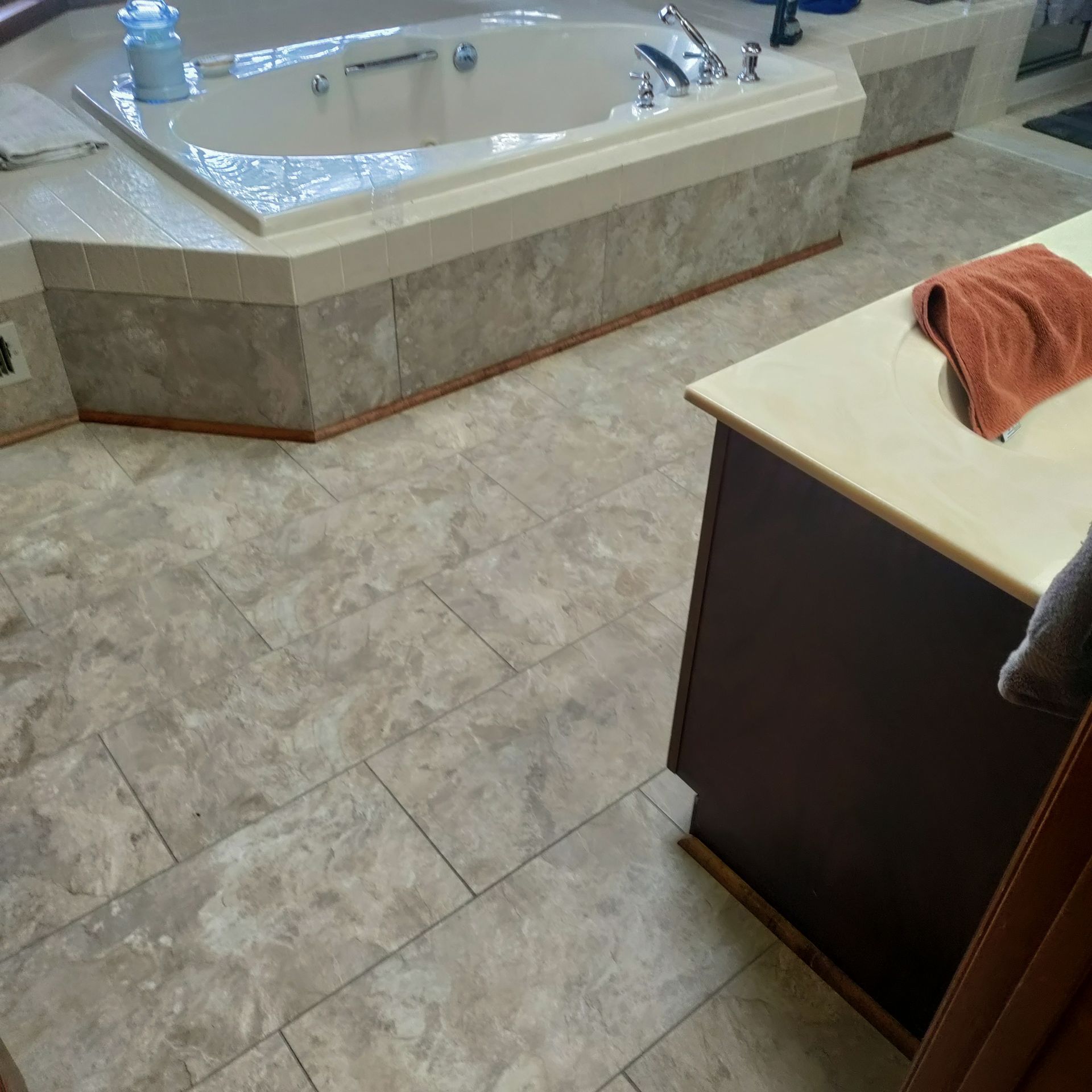 A bathroom with a bathtub and a towel on the counter