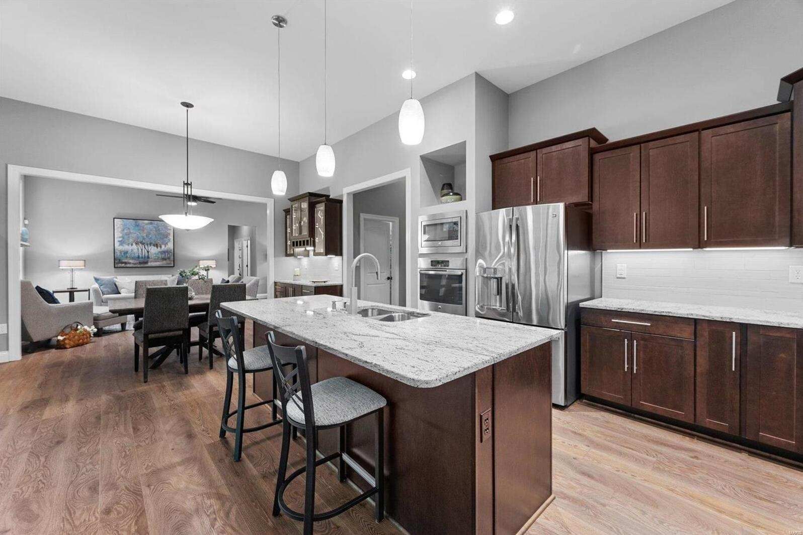 A kitchen with a large island and stainless steel appliances.