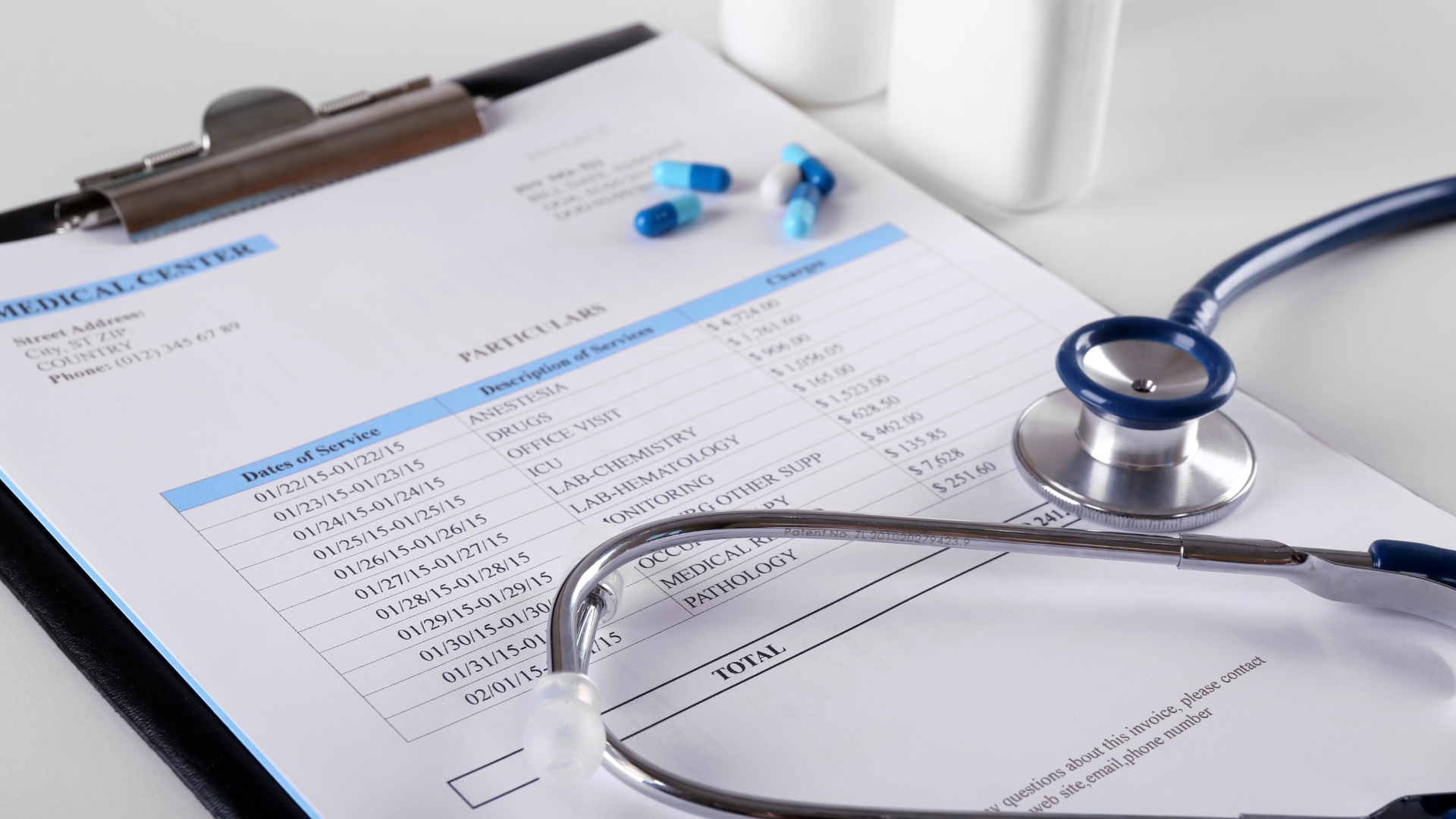 A nurse is using a calculator and a laptop computer