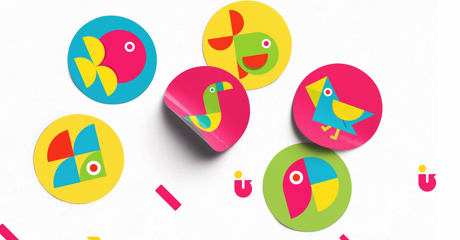 Colorful circular stickers with bird and fish designs.