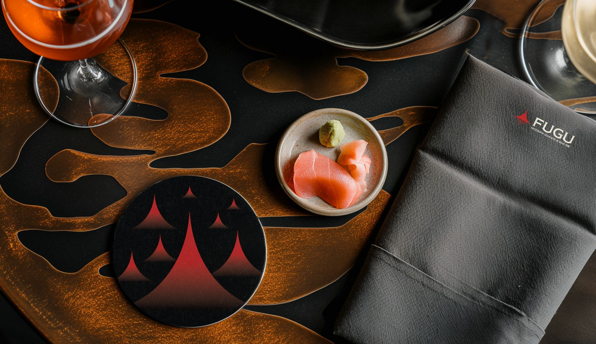 Sushi with drink and coaster on a decorative table at Fugu restaurant.