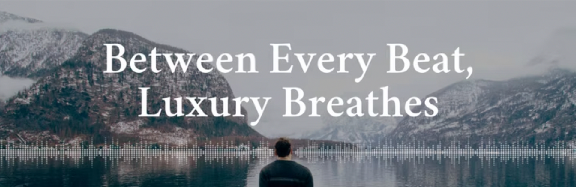 Person looking at a lake with snowy mountains in the background. Text overlay: 