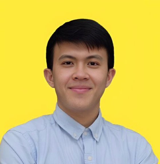 Woman wearing yellow beret and sweater, looking through binoculars, orange background.