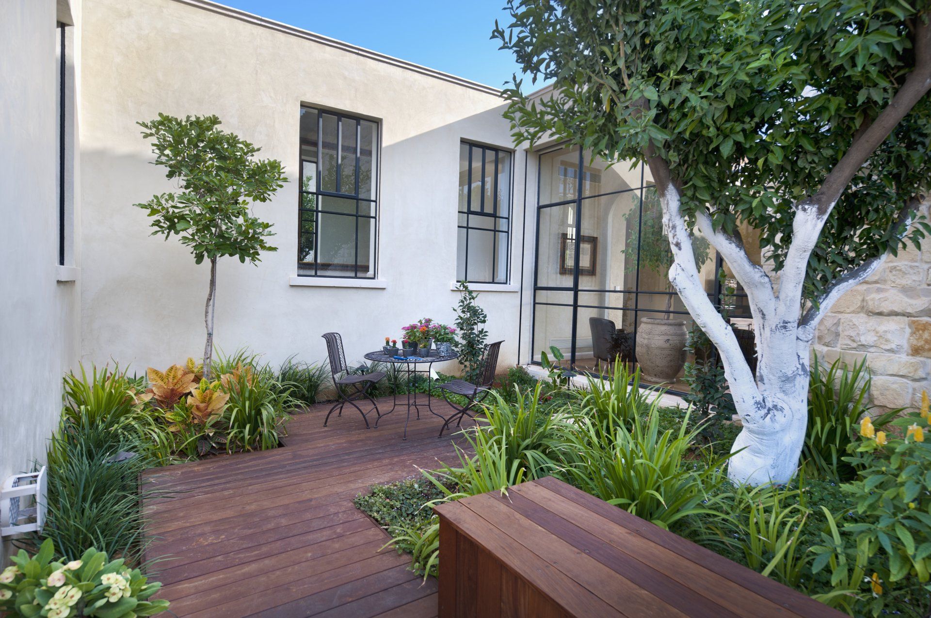 Custom Trex Decking with trees and planters installed in Yorba Linda CA by Yorba Landscaping